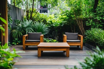 Fototapeta premium A charming outdoor scene featuring two elegant wooden chairs and a matching table, surrounded by diverse greenery, conveying tranquility and sophistication.