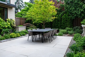 A spacious outdoor dining area surrounded by lush greenery, featuring a large table with wicker chairs. Perfect for stylish and comfortable al fresco dining.