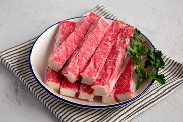 Organic Imitation Crab Meat Sticks on a Plate, side view. © Liudmyla