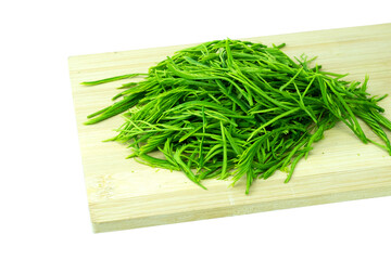 Heap of fresh Senegalia pennata (Acacia pennata) leaves or Cha-om in Thai on wooden cutting board, isolated on white background with clipping path close up stacking