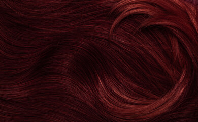 Dark red hair close-up as a background. Women's long brown hair. Beautifully styled wavy shiny...