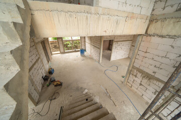 Under construction home or house with scaffolding on site in village. Old unfurnished rental property, living space units. lifestyle. Renovation.