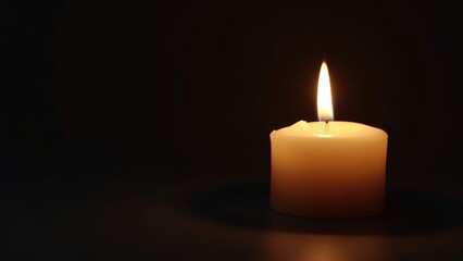 Solitary Candle with Subtle Flame on Dark Surface Highlighting Warmth