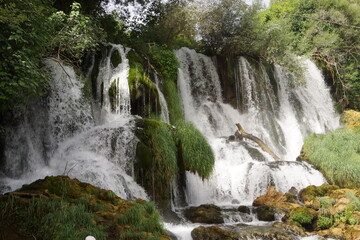 The wonderful streams of the Kravica waterfall, surrounded by greenery, in Ljubuski (Bosnia and Herzegovina)