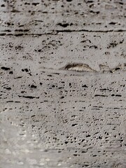 Rustic travertine stone wall of an old structure