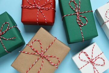 Beautiful gift boxes tied with bows on color background 