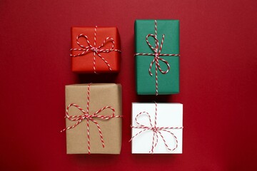 Beautiful gift boxes tied with bows on color background 