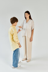 Fototapeta premium A mother interacts with her son who has hearing impairment, fostering understanding and connection.