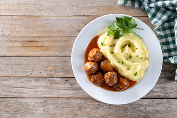 Meatballs with mashed potatoes on wooden table. Top view. Copy space