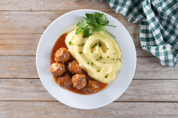 Meatballs with mashed potatoes on wooden table. Top view