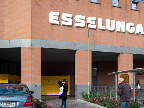 Esselunga supermarket building with customers walking and shopping carts