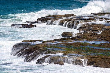 Waves crashing on a rock ledge