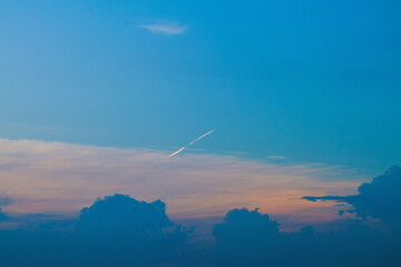 Summer evening sky in the picturesque clouds, lit by the rays of the setting sun.