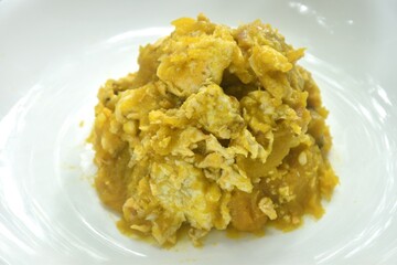 stir fried pumpkin mixed with egg on plate