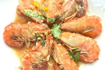 deep fried salty river shrimp with chop garlic and pepper in fish sauce arranging on plate 