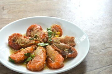 deep fried salty river shrimp with chop garlic and pepper in fish sauce arranging on plate 