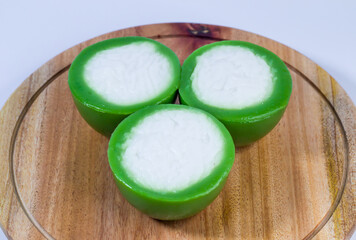 Three Layer Cakes: A trio of vibrant, green-layered cakes, each crowned with a fluffy white...