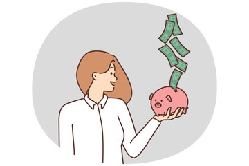 Smiling woman with piggybank excited with cash flow