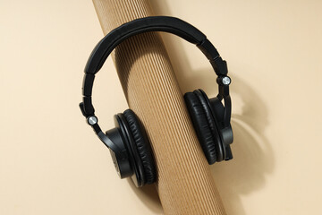 Over-ear, black headphones, on a dark background.