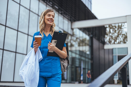 Smiling Medical Professional Walking Outdoors with Coffee and Clipboard - Powered by Adobe