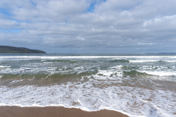 waves crashing with a dark sky above 