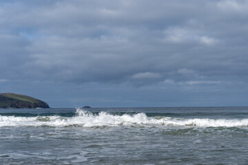 waves crashing with a dark sky above 