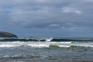 waves crashing with a dark sky above 