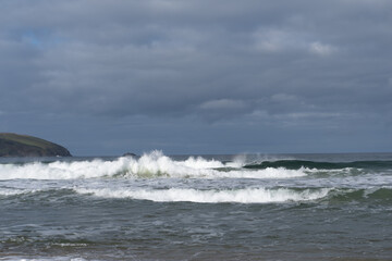 waves crashing with a dark sky above 