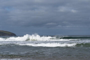 waves crashing with a dark sky above 