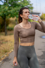 close up on the street on the river embankment in the city center a brunette girl in a brown top...