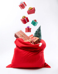 Santa's red sack filled with colorful Christmas gifts floating or flying isolated on Clean White background