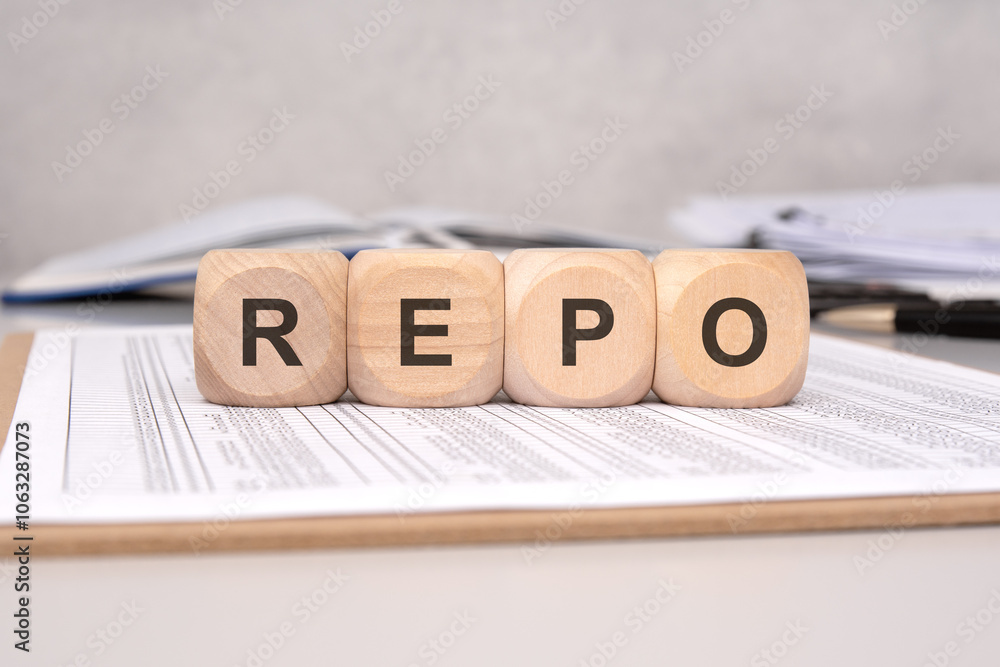 Poster wooden blocks arranging the letters repo on various financial documents and reports