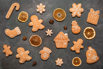 Collection of Christmas gingerbread cookies on dark rustic background, top view, flat lay