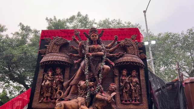 Devi Durga idol with bronze look at carnival procession at Red Road in Kolkata, India.