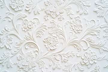 Fototapeta premium The image displays a close-up view of a wallpaper with intricate floral patterns and ornate designs. The texture is thick and the design adds an elegant touch to any room.