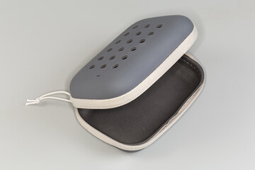 Open empty plastic soft case with zipper on gray background