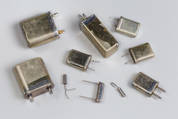 Old different crystal oscillators in metallic packages on gray background