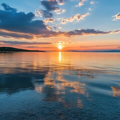 Summer sunset reflecting off calm, crystal-clear waters 