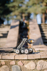 A rugged inspection robot positioned on stone steps, highlighting its mobility and adaptability for outdoor and uneven terrain..
