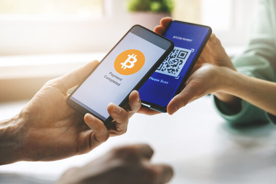 bitcoin payment - person using smart phone to pay with crypro