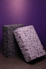 stylish dark sponges for washing dishes and cleaning on a purple background