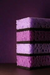 stylish dark sponges for washing dishes and cleaning on a purple background