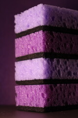 stylish dark sponges for washing dishes and cleaning on a purple background