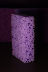 stylish dark sponges for washing dishes and cleaning on a purple background