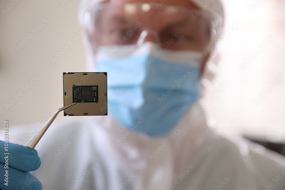 Poster man in mask holding computer chip on blurred background, selective focus