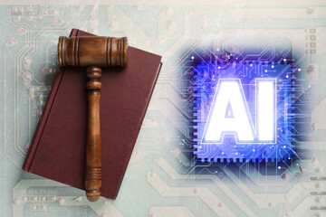 Artificial intelligence and law. Wooden gavel on book and AI abbreviation