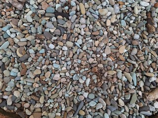 Pile of colorful gravel pebble stones background with various sizes. Beautiful patterns, space for work, banner, wallpaper close up