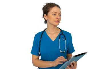Young nurse in scrubs efficiently using a tablet for patient care