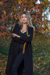  Autumn - winter collection. Blonde woman in wool coat on a city park background. Modern classical ladies wardrobe