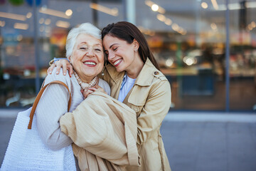 Joyful Grandmother and Granddaughter Embracing Outside a Shopping Mall